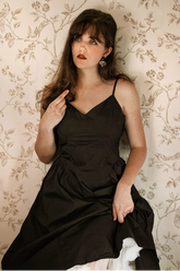 a lady in a black spaghetti strap dress